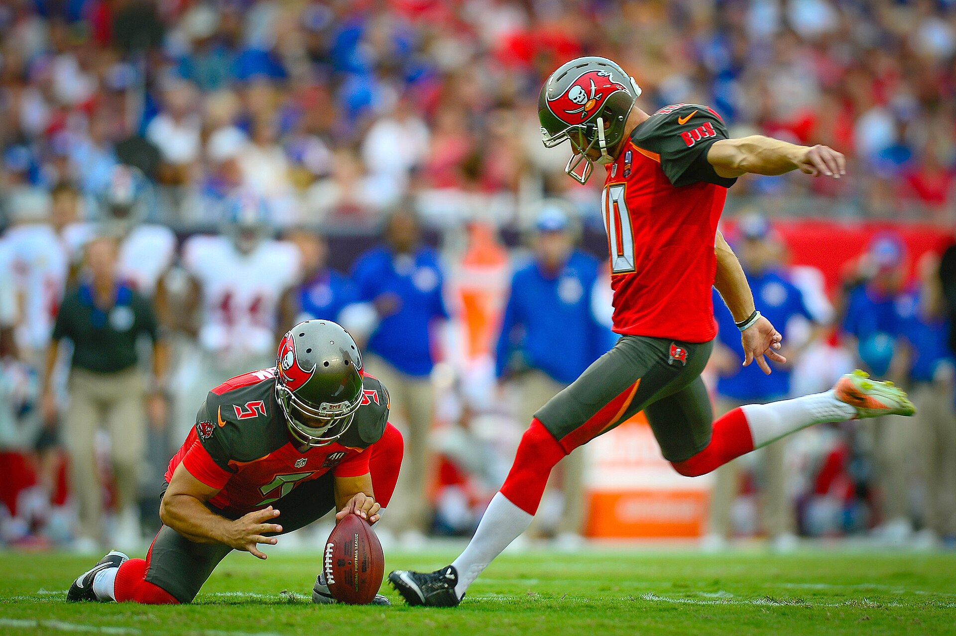 A football kicker lines up for a field goal